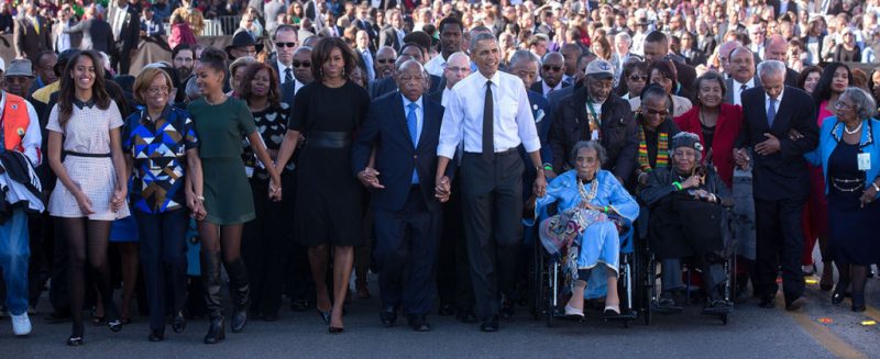 The Obama family join hands as they begin the march with the foot soldiers across the Edmund Pettus Bridge. (Official White House Photo by Lawrence Jackson)