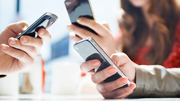 hands texting with mobile phones in cafe hands texting with mobile phones